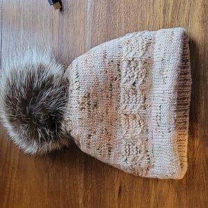 Hand knit wool cap with real racoon fur pom